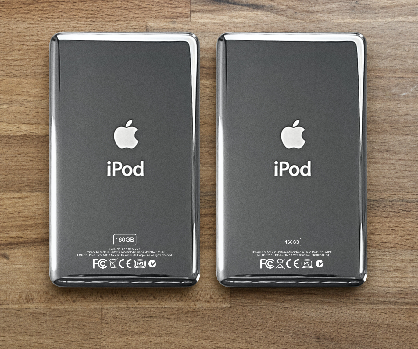 Back engraving comparison showing different serial-number positions on thick and thin 160GB iPods
