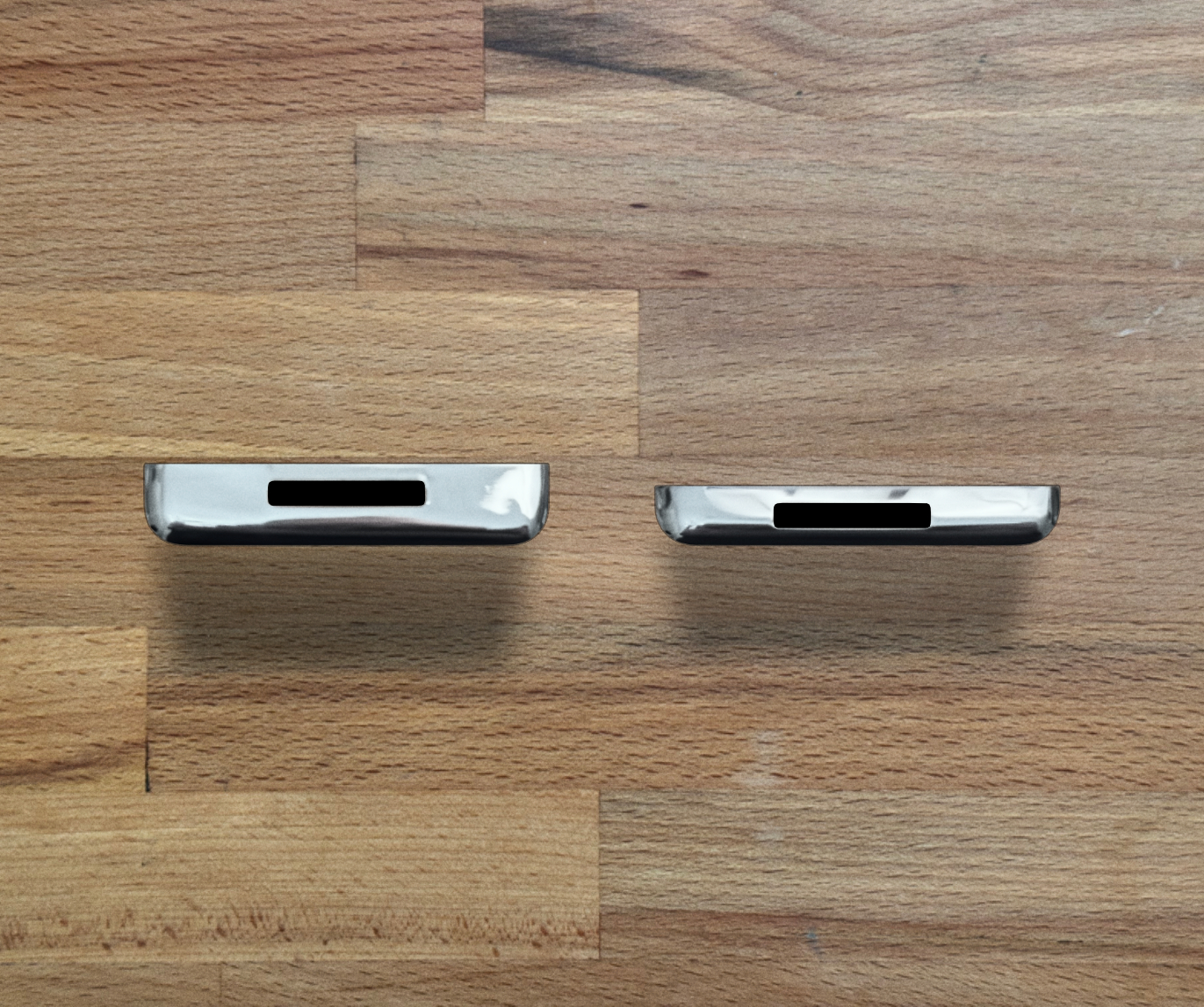 Bottom-edge comparison showing a thick 160GB iPod back on the left and a thin 160GB iPod back on the right